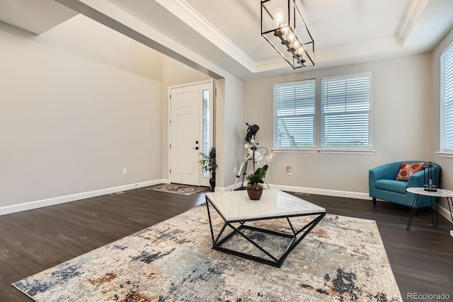 1403 Hart Ln, Elizabeth, CO 80107 - living area featuring crown molding, a tray ceiling, dark wood-style flooring, baseboards, and a chandelier