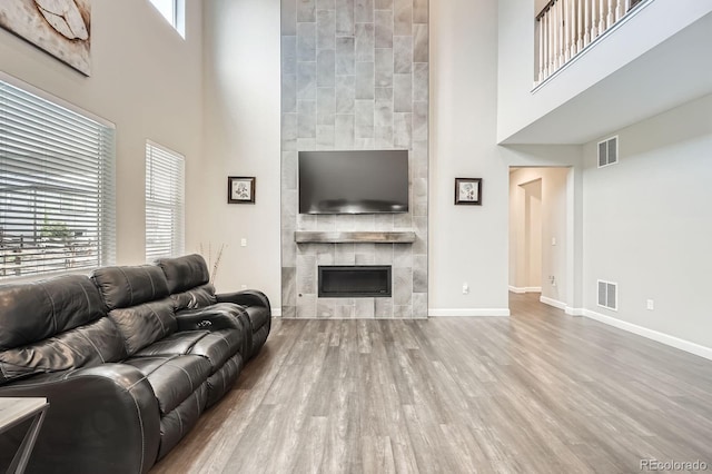 1403 Hart Ln, Elizabeth, CO 80107 - living room with a high ceiling, a fireplace, wood finished floors, and baseboards