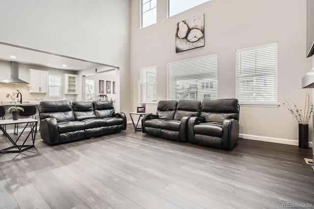 1403 Hart Ln, Elizabeth, CO 80107 - living room featuring wood finished floors, a towering ceiling, and baseboards