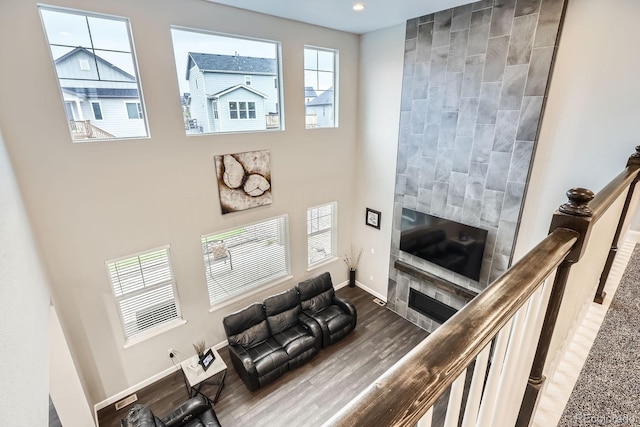 1403 Hart Ln, Elizabeth, CO 80107 - living room with a fireplace, baseboards, wood finished floors, a towering ceiling, and recessed lighting