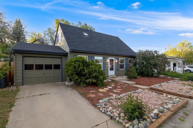 1565 Sagrimore Cir, Lafayette, CO 80026 - cape cod house with an attached garage, concrete driveway, and roof with shingles