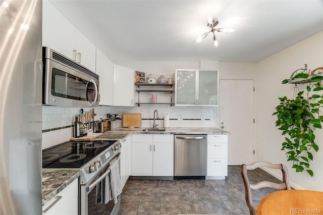 1565 Sagrimore Cir, Lafayette, CO 80026 - kitchen with stainless steel appliances, backsplash, open shelves, and white cabinetry