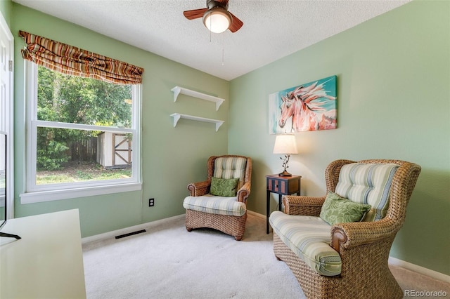 1565 Sagrimore Cir, Lafayette, CO 80026 - sitting room with carpet flooring, healthy amount of natural light, a ceiling fan, and a textured ceiling