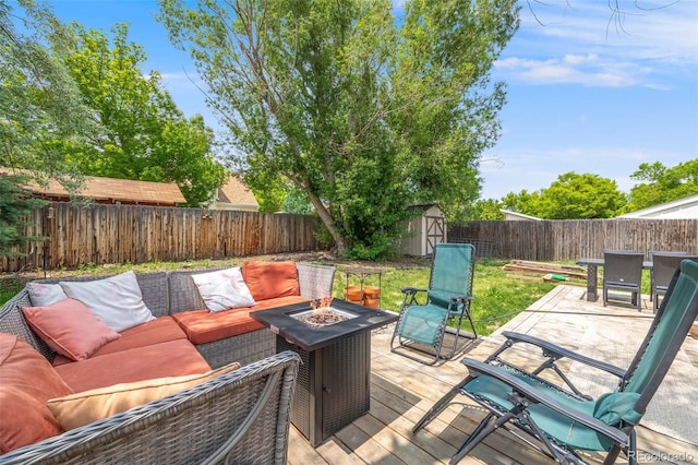 1565 Sagrimore Cir, Lafayette, CO 80026 - wooden terrace with an outdoor living space with a fire pit, a fenced backyard, and a shed