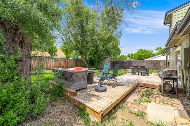 1565 Sagrimore Cir, Lafayette, CO 80026 - deck featuring a storage unit, outdoor dining area, a fenced backyard, and a grill
