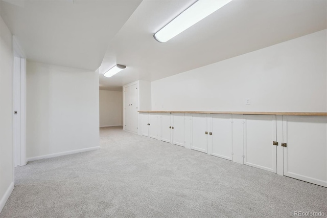 interior space featuring baseboards and carpet floors