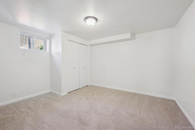 unfurnished bedroom with carpet floors, a closet, and baseboards