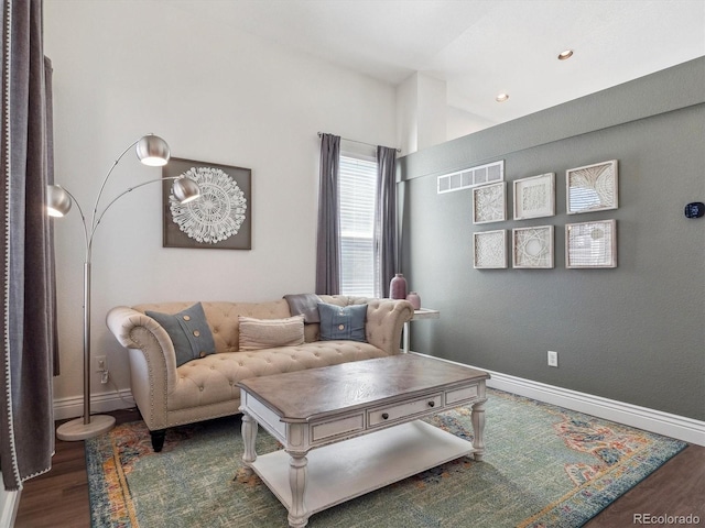 living area featuring wood finished floors, baseboards, and recessed lighting