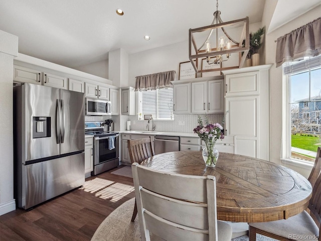 kitchen featuring stainless steel appliances, plenty of natural light, decorative backsplash, a sink, and recessed lighting