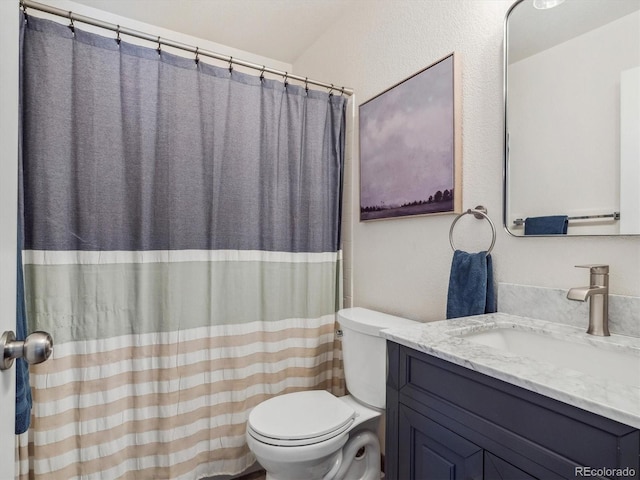 full bathroom featuring toilet, vanity, and a shower with shower curtain