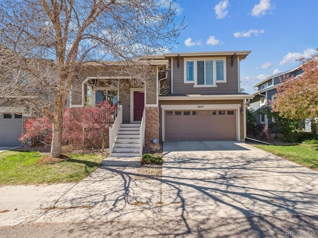 view of front of house with a garage, driveway, and stone siding