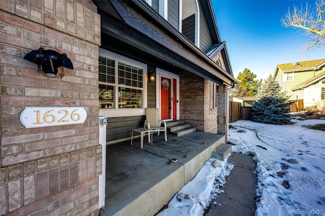 view of snow covered property entrance