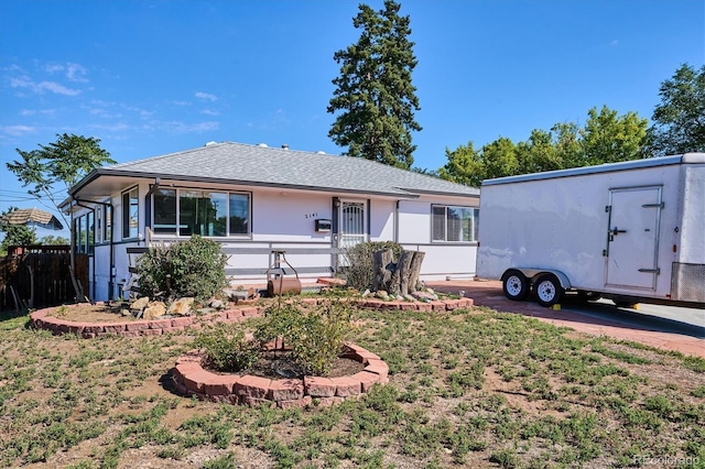 2141 W Gill Pl, Denver, CO 80223 - view of front of property with stucco siding and roof with shingles