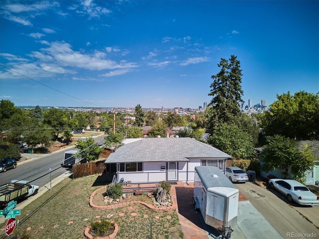 2141 W Gill Pl, Denver, CO 80223 - view of front of property with a shingled roof and concrete driveway