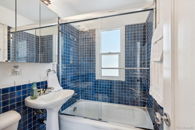 2141 W Gill Pl, Denver, CO 80223 - full bath with tile walls, combined bath / shower with glass door, and healthy amount of natural light