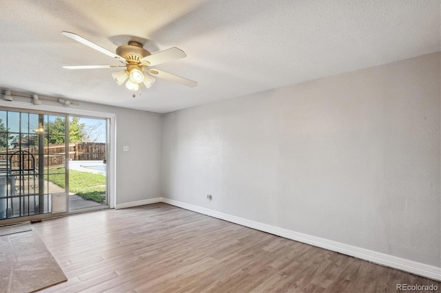 2141 W Gill Pl, Denver, CO 80223 - empty room with wood finished floors, ceiling fan, and a textured ceiling
