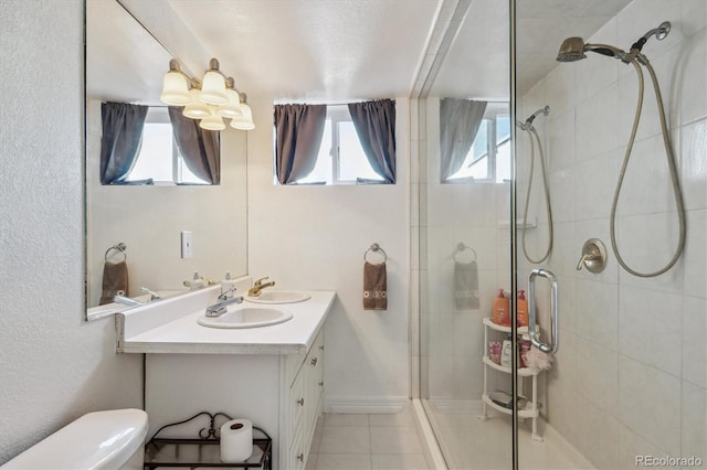 2141 W Gill Pl, Denver, CO 80223 - full bathroom with a shower stall, vanity, and tile patterned flooring