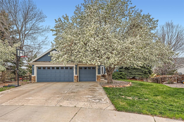obstructed view of property with stone siding, an attached garage, stucco siding, a front yard, and driveway