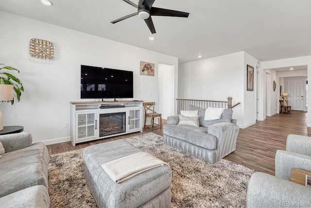 living room with hardwood / wood-style flooring and ceiling fan