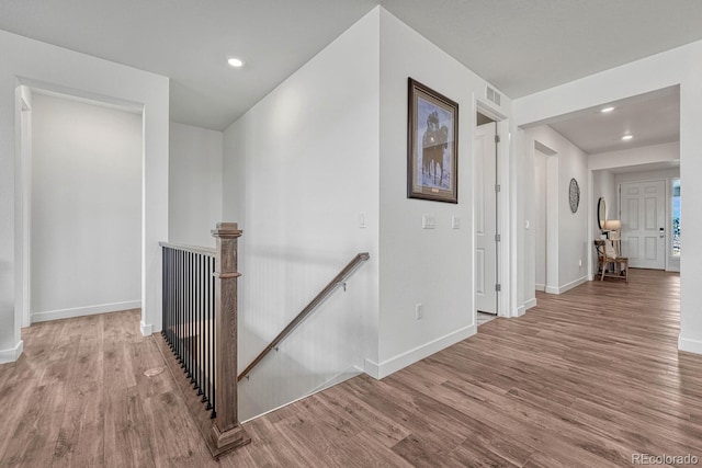 hallway with hardwood / wood-style flooring