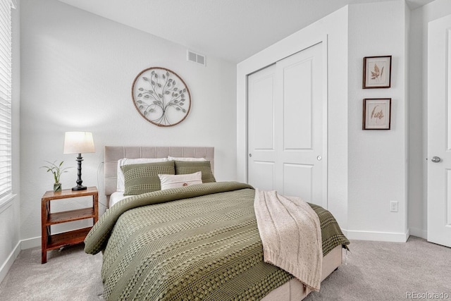 bedroom featuring a closet and light carpet