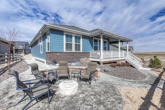 back of property with a patio and covered porch