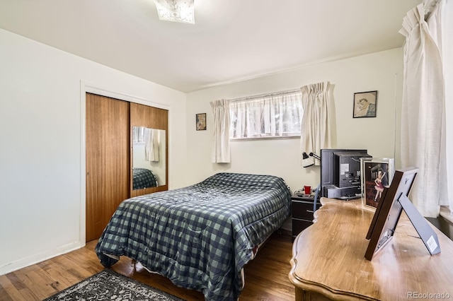 bedroom with a closet and wood finished floors