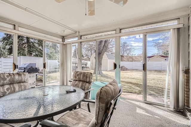 sunroom featuring ceiling fan