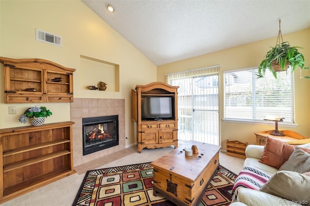 6001 S Yosemite St Unit B203, Greenwood Village, CO 80111 - living area with light carpet, lofted ceiling, a fireplace, and a textured ceiling