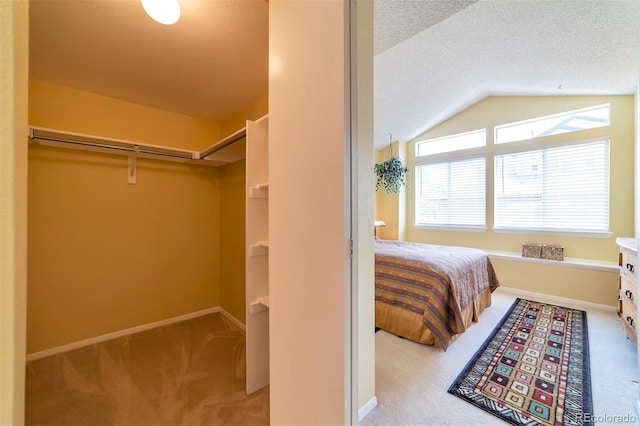6001 S Yosemite St Unit B203, Greenwood Village, CO 80111 - bedroom featuring carpet floors, lofted ceiling, a textured ceiling, and baseboards