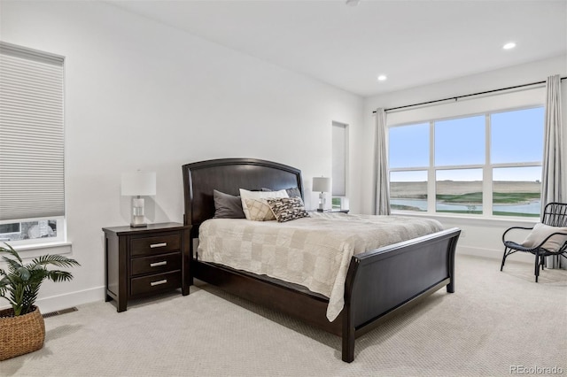 carpeted bedroom featuring a water view