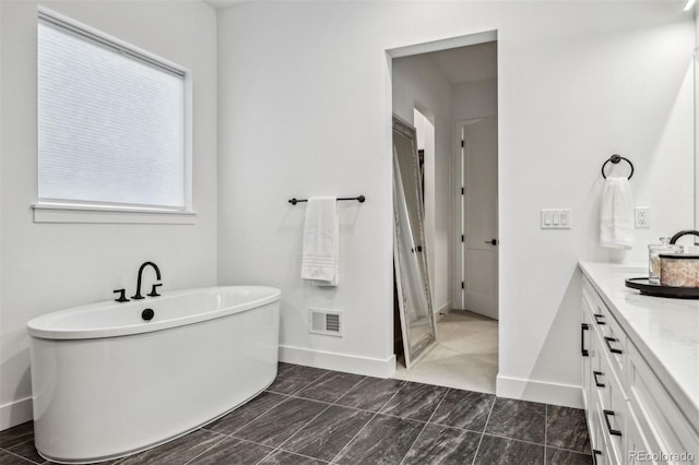 bathroom with vanity and a tub to relax in