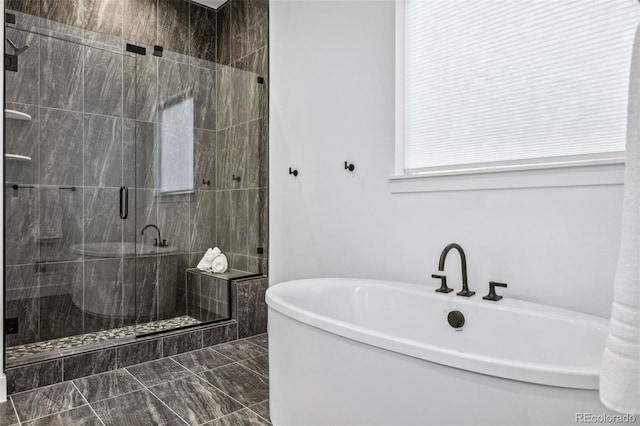 bathroom featuring shower with separate bathtub