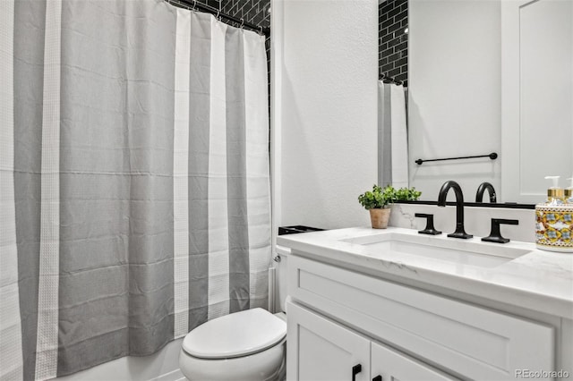 full bathroom with vanity, shower / tub combo with curtain, and toilet