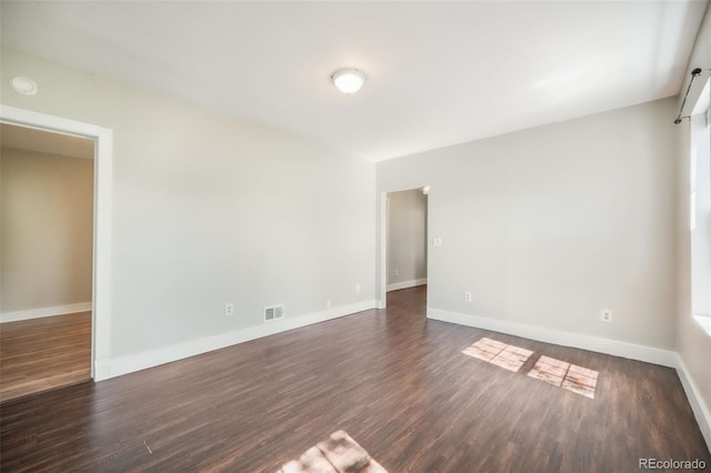 614 W Kiowa St, Colorado Springs, CO 80905 - spare room featuring dark wood finished floors, baseboards, and a smoke detector