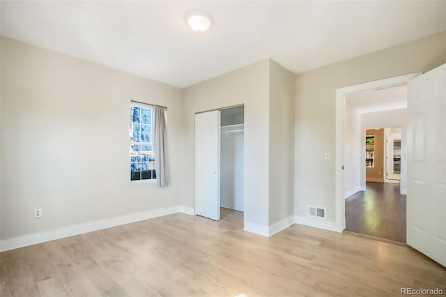 614 W Kiowa St, Colorado Springs, CO 80905 - unfurnished bedroom featuring light wood-style floors, baseboards, and a closet