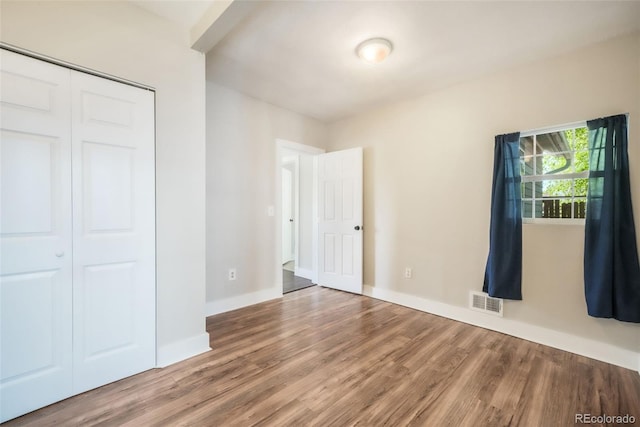 614 W Kiowa St, Colorado Springs, CO 80905 - unfurnished bedroom featuring wood finished floors, a closet, and baseboards