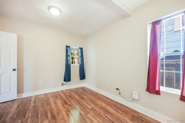 614 W Kiowa St, Colorado Springs, CO 80905 - empty room with wood finished floors, beamed ceiling, and baseboards