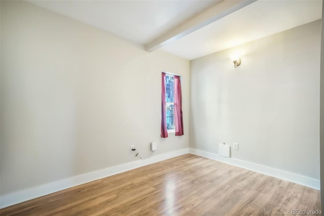 614 W Kiowa St, Colorado Springs, CO 80905 - spare room featuring beam ceiling, light wood-type flooring, and baseboards