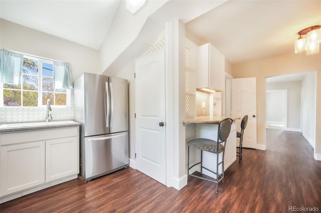 614 W Kiowa St, Colorado Springs, CO 80905 - kitchen featuring freestanding refrigerator, dark wood-type flooring, a sink, and white cabinetry