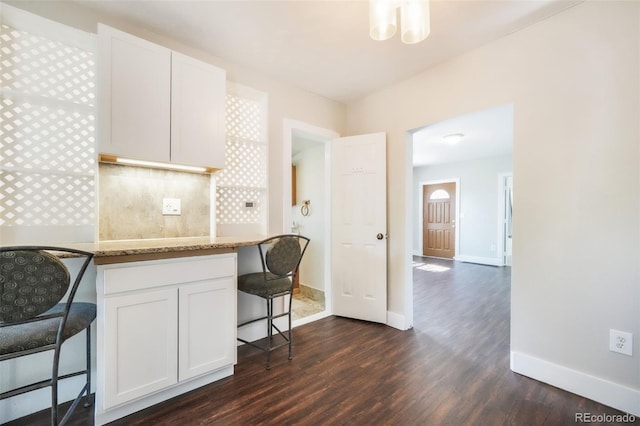 614 W Kiowa St, Colorado Springs, CO 80905 - kitchen with dark wood-style flooring, baseboards, and white cabinetry