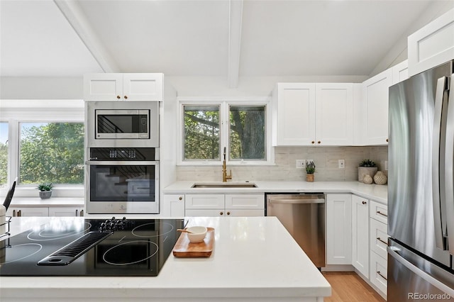 5616 S Kenton Ct, Englewood, CO 80111 - kitchen featuring stainless steel appliances, a sink, decorative backsplash, and healthy amount of natural light