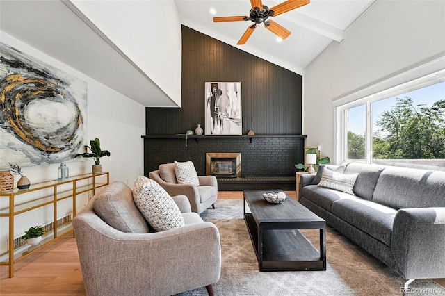 5616 S Kenton Ct, Englewood, CO 80111 - living room featuring high vaulted ceiling, light wood finished floors, ceiling fan, a fireplace, and beamed ceiling