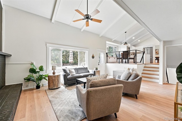 5616 S Kenton Ct, Englewood, CO 80111 - living area with beam ceiling, plenty of natural light, light wood finished floors, ceiling fan, and stairs