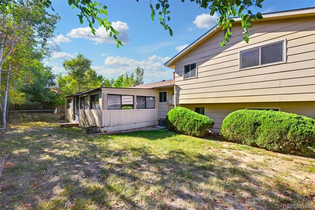 back of house featuring a yard