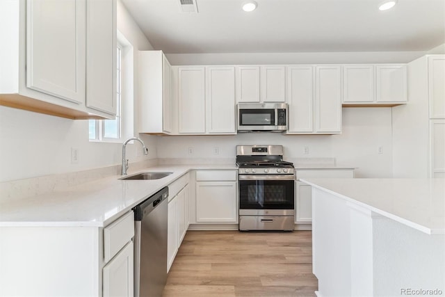 449 S Salida St, Aurora, CO 80017 - kitchen featuring stainless steel appliances, a sink, recessed lighting, white cabinetry, and light countertops