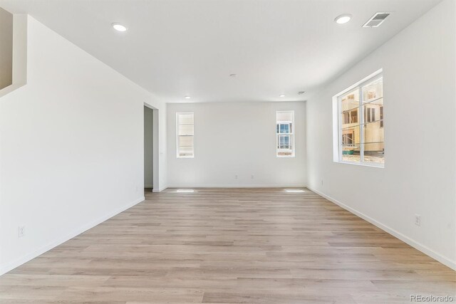 449 S Salida St, Aurora, CO 80017 - spare room with healthy amount of natural light, recessed lighting, light wood-style floors, and baseboards