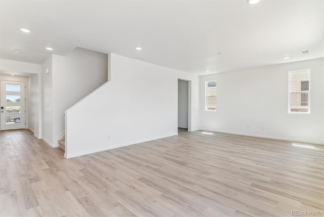 449 S Salida St, Aurora, CO 80017 - spare room with light wood-type flooring, recessed lighting, stairway, and baseboards