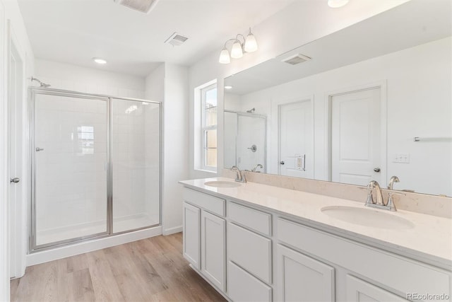 449 S Salida St, Aurora, CO 80017 - full bathroom with a shower stall, wood finished floors, and double vanity