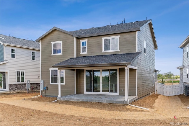 449 S Salida St, Aurora, CO 80017 - back of house featuring a patio, a shingled roof, and cooling unit